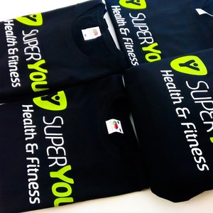 Photo of t-shirts with SuperYou Health and Fitness branding