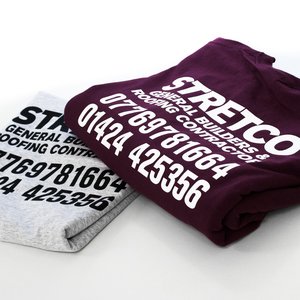 Photo of t-shirts with STRETCO building and roofing contractor business branding