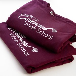 Photo of burgundy t-shirts with The Essential Wine School branding